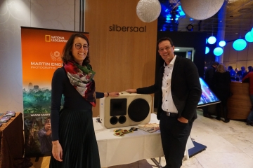 Die iDEALTOURS-Geschäftsleitung Susanne und Christof Neuhauser zeigen sich sichtlich erfreut über die hippe Strohfeld Musicbox, die beim Reisefestival für Stimmung sorgte.